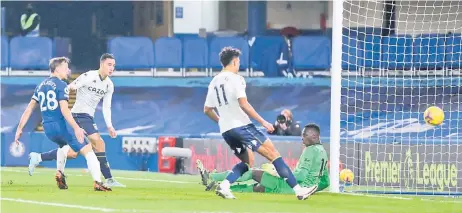  ?? — AFP photo ?? Aston Villa’s Anwar El Ghazi (second left) shoots to score the equalising goal past Chelsea goalkeeper Edouard Mendy during the English Premier League match at Stamford Bridge in London.