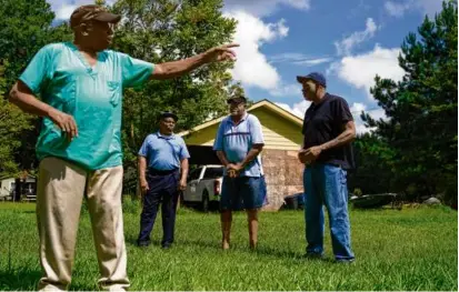  ?? ERIK VERDUZCO/ASSOCIATED PRESS ?? The Rev. Elijah Smalls Jr., with, from left, Jonathan Ford, his brother Fred Smalls, and Richard Habersham, gave a tour of his family’s property near Mount Pleasant, S.C.