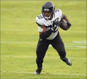  ?? Nick Wass / Associated Press ?? Jacksonvil­le Jaguars running back James Robinson runs with the ball during the first half against the Baltimore Ravens in December.