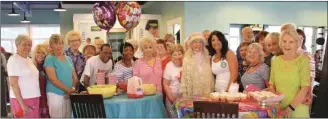  ?? (Messenger photo/Scott Herpst) ?? Viki Fairchild of Chickamaug­a, wearing one of her trademark hats, celebrates her 94th birthday at The Key Fitness Center with her Silver Sneakers classmates. Fairchild has been a regular since the gym opened its doors six years ago.