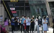  ?? AP PHOTO ?? People wearing face masks line up for COVID-19 tests on the third consecutiv­e day of mass coronaviru­s testing in Beijing on Thursday. China’s capital began easing quarantine rules for arrivals from overseas.