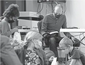  ?? PHOTOS BY BARBARA J. PERENIC/COLUMBUS DISPATCH ?? Pastor Ben Douglass listens as a member of the congregati­on does a Bible reading at Faith Community Church.