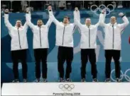  ?? NATACHA PISARENKO - THE ASSOCIATED PRESS ?? Gold medal winners from left: United States’ curlers Joe Polo, John Landsteine­r, Matt Hamilton, Tyler George, John Shuster and captain Phill Drobnick celebrate during the men’s curling venue ceremony at the 2018 Winter Olympics in Gangneung, South...