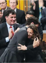  ?? SEAN KILPATRICK / THE CANADIAN PRESS ?? Prime Minister Justin Trudeau hugs Foreign Affairs Minister Chrystia Freeland after her speech in the House of Commons Tuesday, where she noted that Canada cannot “rely solely on the U.S. security umbrella.”