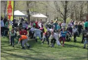  ?? NEWS-HERALD FILE ?? Children race to roll a wooden egg across the finish line during the Annual Easter Monday Egg Roll at the James A. Garfield National Historic Site in 2019.