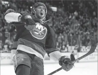  ?? KATHY WILLENS, THE ASSOCIATED PRESS ?? Islanders centre Brock Nelson celebrates his game-winning goal in overtime in New York on Monday night. The Islanders beat the Toronto Maple Leafs 6-5.