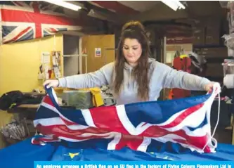  ?? — AFP ?? An employee arranges a British flag on an EU flag in the factory of Flying Colours Flagmakers Ltd in Knaresboro­ugh, northern England on Feb 7, 2019.