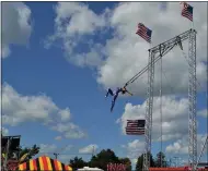  ?? SHEENA HOLLAND DOLAN — THE NEWS-HERALD ?? Acrobatics artist Lyric Wallenda performs one of her most difficult maneuvers at the Great Geauga County Fair, where she is suspended only by a short rope around the back of her neck.