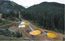  ?? Brennan Linsley / Associated Press 2015 ?? Water flows in 2015 through a series of retention ponds built to contain chemicals from a mine outside Silverton, Colo.