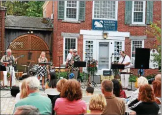  ?? PHOTOS BY JOHN FITTS — THE REGISTER CITIZEN MEDIA. REGISTER CITIZEN.COM ?? Above, the No Stress Band entertaine­d in Cobble Court During the Litchfield Night Out event on Thursday. Online: To see more photos, go to