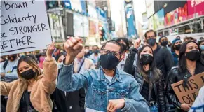  ?? — Reuters ?? Strength in numbers: Asians attending a Stop Asian Hate rally at Times Square in New York City.