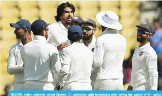  ??  ?? NAGPUR: Indian cricketer Ishant Sharma (C) celebrates with teammates after taking the wicket of Sri Lanka batsman. — AFP