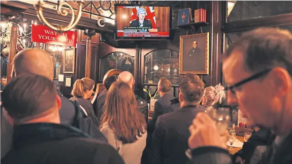  ?? Pictures: Getty. ?? Drinkers at the Red Lion pub in London watch a live broadcast of Prime Minister Theresa May’s speech yesterday evening.