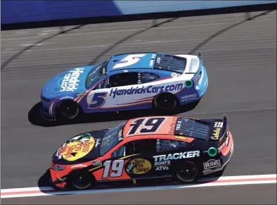  ?? Sean Gardner / Getty Images ?? Kyle Larson (5) and Martin Truex Jr. drive during practice for the NASCAR Cup Series Folds of Honor QuikTrip 500 at Atlanta Motor Speedway on Saturday.