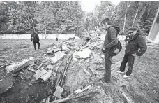  ?? AP/ANDRII MARIENKO ?? PEOPLE look at fragments of the television tower that was broken in half after it was hit by a Russian missile in Kharkiv, Ukraine on Monday, April 22, 2024.