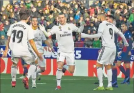  ?? AP ?? ▪ Gareth Bale (centre) celebrates the all-important goal with Real Madrid teammates on Sunday.