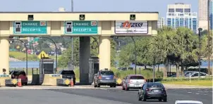  ?? JACOB LANGSTON/STAFF PHOTOGRAPH­ER ?? Vehicles travel through a toll plaza on State Road 408. The SunPass toll system is about to get an upgrade that will keep clients from adding cash or making changes to accounts for nearly a week.