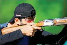  ??  ?? Taking aim UAE’s Dhaher Al Aryani in the men’s trap qualificat­ion at the Royal Artillery Barracks Excel centre on Monday.
AFP