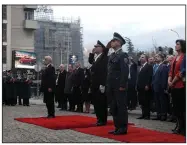  ?? (AP/Boris Grdanoski) ?? North Macedonia’s parliament speaker Talat Xhaferi (from center left), a Bulgarian army officer and a Slovenian army officer salute the NATO flag Feb. 11 during a flag raising ceremony in front of the parliament building in Skopje, North Macedonia.