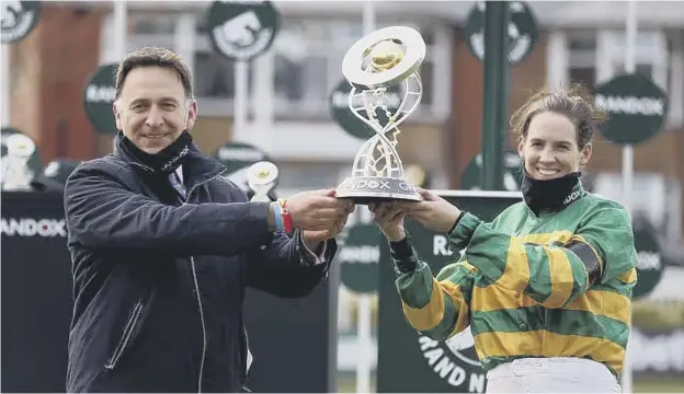  ??  ?? 0 Jockey Rachael Blackmore and trainer Henry De Bromhead receive the Grand National trophy after winning with Minella Times