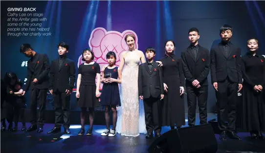  ??  ?? GIVING BACK Cathy Lee on stage at the Amfar gala with some of the young people she has helped through her charity work