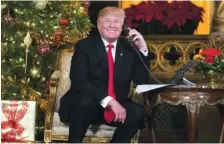  ?? THE ASSOCIATED PRESS ?? President Donald Trump speaks on the phone with children Sunday as they track Santa’s movements with the North American Aerospace Defense Command Santa Tracker at the president’s Mar-a-Lago estate in Palm Beach, Fla.