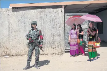  ??  ?? ON GUARD: Soldiers stationed at checkpoint­s along the once conflict-ridden road to Loi Tai Leng.