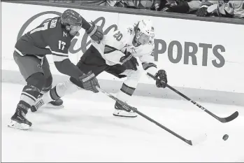  ?? PHOTOS BY STACY BENGS — THE ASSOCIATED PRESS ?? The Sharks’ Marcus Sorensen (20) handles the puck against the Wild’s Marcus Foligno (17) during the first period on Friday in St. Paul, Minn. The Wild defeated the Sharks, 3-2.