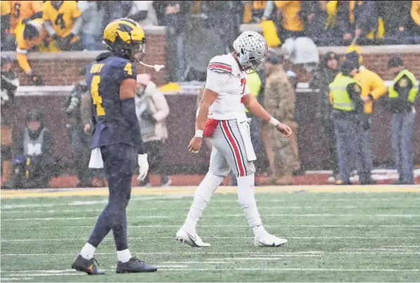  ?? PHOTOS BY ADAM CAIRNS/COLUMBUS DISPATCH ?? OSU quarterbac­k C.J. Stroud walks off the field as Michigan was ending its eight-game losing streak to the Buckeyes.