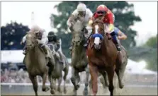  ?? JULIO CORTEZ — THE ASSOCIATED PRESS ?? Justify, right, with jockey Mike Smith up, crosses the finish line to win the 150th running of the Belmont Stakes horse race and the Triple Crown, Saturday in Elmont, N.Y. Gronkowski (6), with jockey Jose Ortiz up, was second.