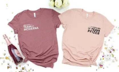  ??  ?? In the pink … Team Moderna and Team Pfizer T-shirts. Photograph: Pinehart/Etsy