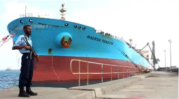  ??  ?? File photo of a security guard standing by a ship docked in the southern Yemeni port of Aden. — AFP photo