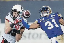  ?? CANADIAN PRESS FILE PHOTO ?? Blue Bombers' Maurice Leggett intercepts a pass intended for Ottawa Redblacks’ Greg Ellingson during 2017 CFL action in Winnipeg.