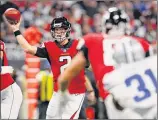 ?? Kevin C. Cox / Getty Images ?? Atlanta’s Matt Ryan threw two touchdown passes in the Falcons’ 27-7 romp over the Dallas Cowboys in Atlanta on Sunday.