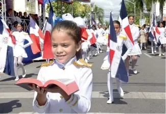  ?? DANNY POLANCO ?? Una niña lleva una biblia en sus manos durante el desfile cívico-militar.