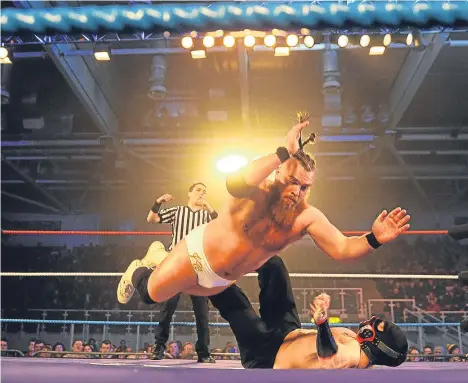  ??  ?? MORE than 2,000 people are thought to have turned out for a televised wrestling exhibition (pictured) at Dundee Ice Arena.
The Dominant Wrestling event featured former WWE star Rey Mysterio.
Event promoter Dan Hinkles said: “I don’t have the official...