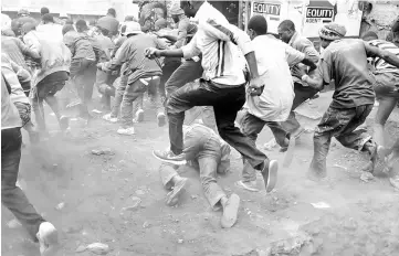  ??  ?? Supporters of Raila Odinga run away from police during clashes in Kibera slum in Nairobi. — Reuters photo