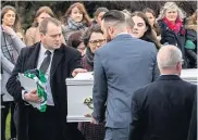  ??  ?? GRIEF Andrew Mcginley touches his child’s coffin