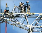  ??  ?? STOPGAP MEASURES: Workers maintain electricit­y pylons to keep the lights on as power infrastruc­ture becomes more dilapidate­d.