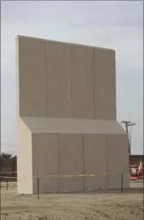  ?? GREGORY BULL, THE ASSOCIATED PRESS ?? A border wall prototype stands in San Diego near Tijuana, Mexico. Companies are nearing an Oct. 26 deadline to finish building models.