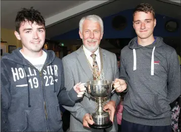  ??  ?? Cllr. Jim Moore presenting Bill Crowdle and Gary Murphy with the trophy for most wins for the New Ross Parks camp.