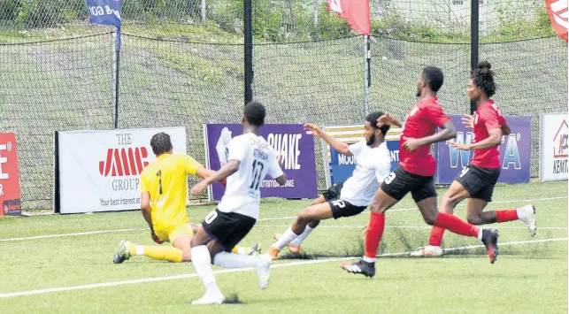  ?? IAN ALLEN/PHOTOGRAPH­ER ?? Arnett Garden’s Goalkeeper Chadeem Rodriques (left) watches as a shot from Shaniel Thomas (centre) of Cavalier rolls into his net during their Jamaica Premier League game at the UWI/JFF Captain Horace Burrell Centre of Excellence in St Andrew yesterday. Also in the photo are Cavalier’s Dwayne Atkinson (left), and Arnett’s Oshane Roberts (second right) and Ezran Simpson.