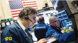  ??  ?? NEW YORK: Traders work on the floor of the New York Stock Exchange on January 29, 2016 in New York City. The Dow Jones Industrial Average rose more than 390 points today. — AFP