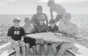  ?? CHRIS LEMIEUX Special to the Miami Herald ?? Capt. Chris Lemieux hooked this 87-pound wahoo and his mate Kole Hawk, rear center, landed the fish in 15 minutes. Lemieux was guiding young anglers ages 12-to-14 during his annual ‘Kid Camp.’