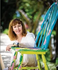  ??  ?? Jo Nagorka sits with a chair she decorated for the breast cancer awareness month “Pink Chair Project” in Jupiter. The project by Jupiter Medical Center and the Margaret W. Niedland Breast Center features chairs decorated by breast cancer survivors, whose designs reflect the inspiratio­n that helped them navigate their diagnosis and treatment.