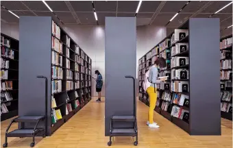  ?? ?? Visitors read books at the Shanghai Library’s new branch. — Jiang Xiaowei