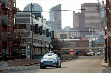  ?? AP File Photo/Keith Srakocic ?? In this 2018 file photo, one of the test vehicles from Argo AI, Ford’s autonomous vehicle unit, navigates through the strip district near the company offices in Pittsburgh.