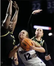  ?? CHARLIE RIEDEL — THE ASSOCIATED PRESS ?? Colorado’s Aaronette Vonleh, left, defends the basket as Kansas State guard Gabby Gregory (12) looks to shoot on Sunday in Manhattan, Kan.