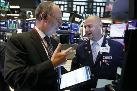 ?? RICHARD DREW — THE ASSOCIATED PRESS ?? Trader Gordon Charlop, left, and specialist Mario Picone work on the floor of the New York Stock Exchange, Thursday.