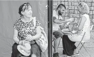  ?? Laszlo Balogh / Associated Press file photo ?? A man administer­s an antibody test in Budapest in July. As infections soar in Hungary, the country's journalist­s and public health officials demand more detailed data from the government.